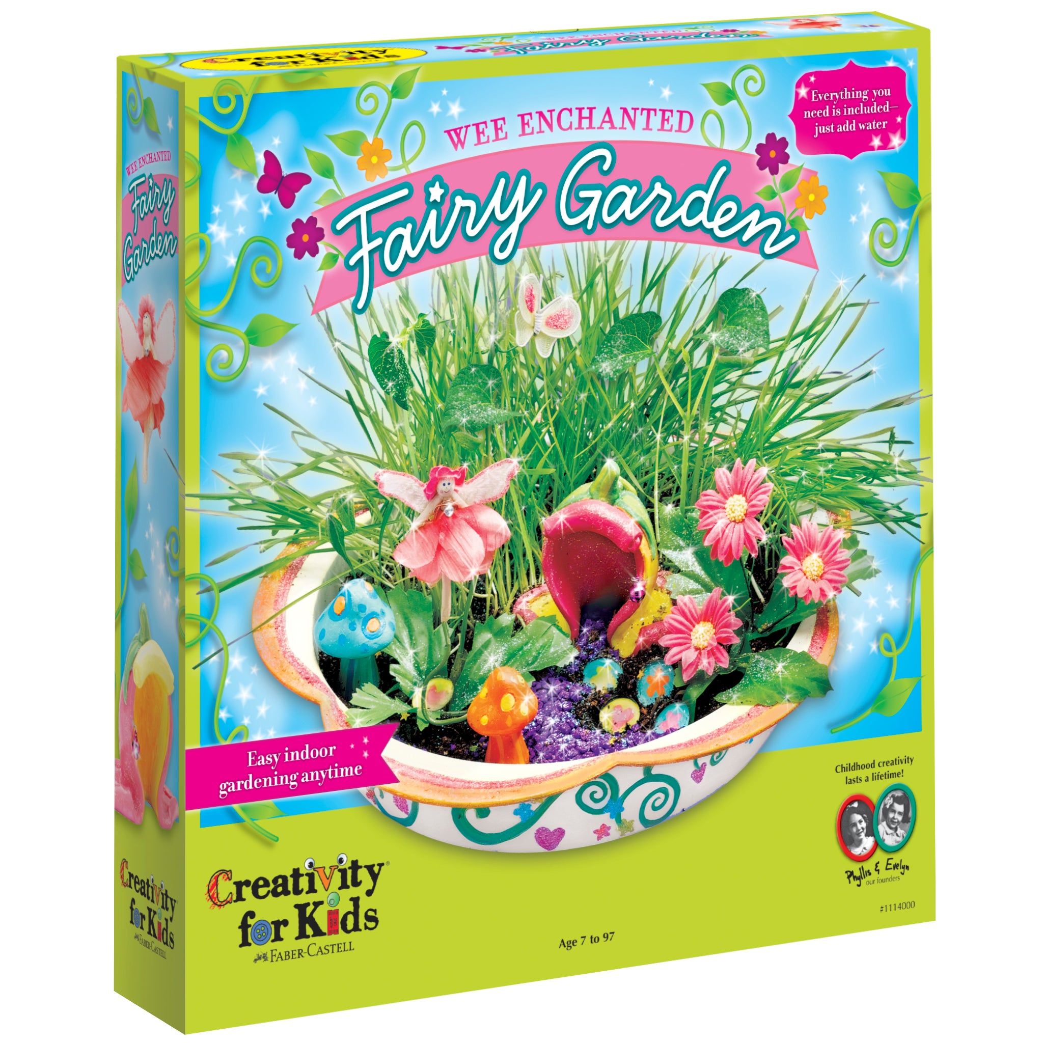 Product box with displaying image of fairy garden. Green grass, ceramic mushrooms, fake flowers, fairy house and fairy. 